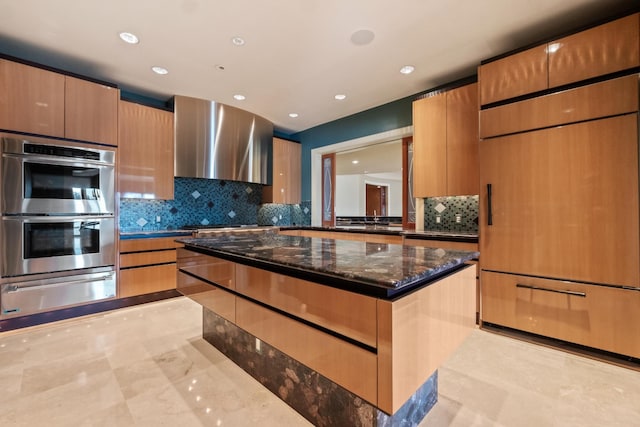 82 Chateaux Du Lac, Fenton, MI 48430 - kitchen with wall chimney range hood, appliances with stainless steel finishes, tasteful backsplash, modern cabinets, and a warming drawer