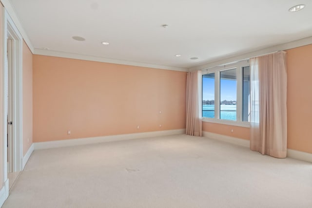 82 Chateaux Du Lac, Fenton, MI 48430 - empty room featuring crown molding, light carpet, baseboards, recessed lighting, and a water view