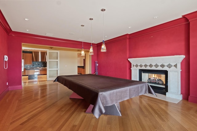 82 Chateaux Du Lac, Fenton, MI 48430 - playroom featuring crown molding, billiards, a multi sided fireplace, and wood finished floors