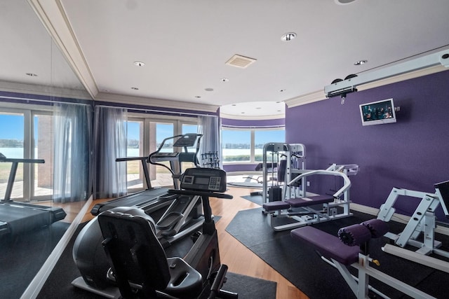 82 Chateaux Du Lac, Fenton, MI 48430 - workout area with visible vents, ornamental molding, and wood finished floors