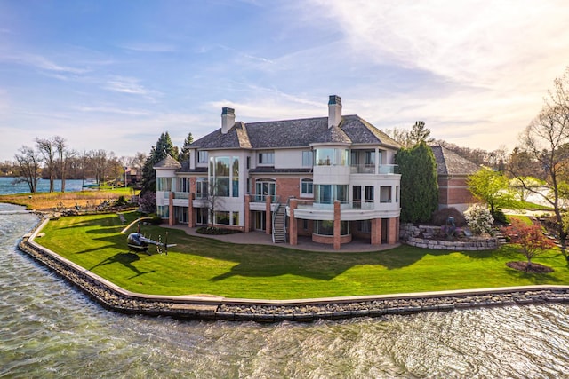 82 Chateaux Du Lac, Fenton, MI 48430 - rear view of property with a water view, a yard, a balcony, and a chimney