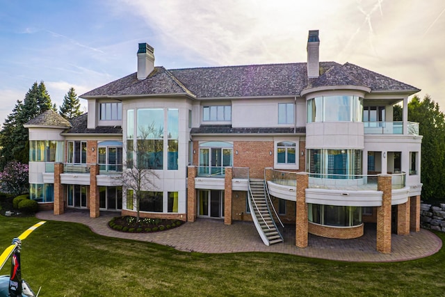 82 Chateaux Du Lac, Fenton, MI 48430 - rear view of property with a lawn, a chimney, a patio area, and a balcony
