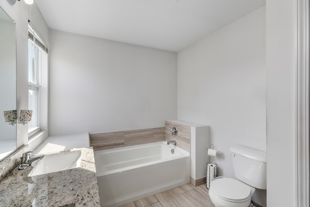 full bathroom featuring a bath, baseboards, toilet, vanity, and wood finished floors
