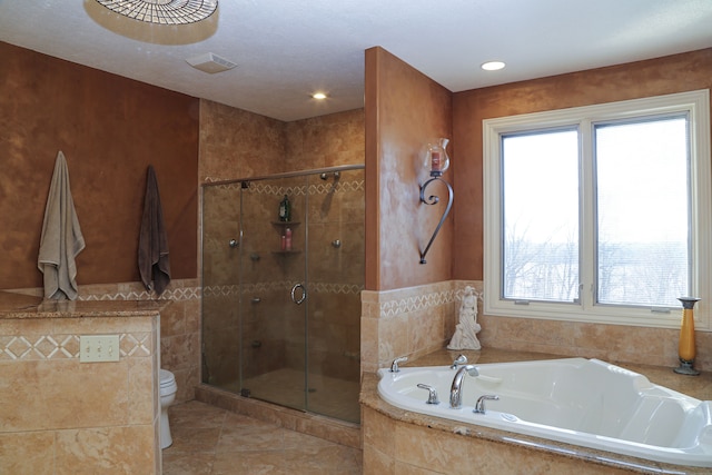 bathroom with a bath, toilet, a stall shower, and a healthy amount of sunlight