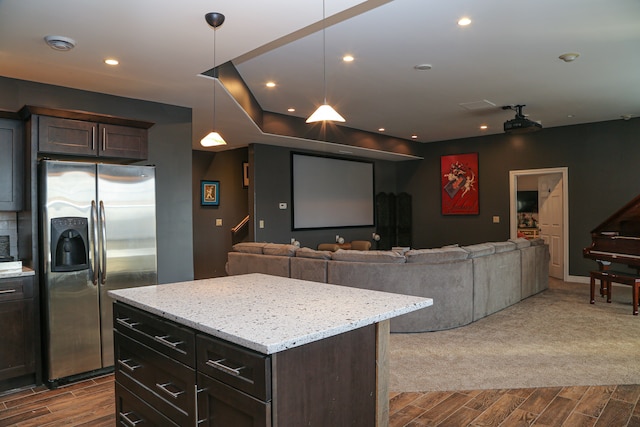 kitchen featuring stainless steel fridge with ice dispenser, open floor plan, wood tiled floor, and dark brown cabinetry