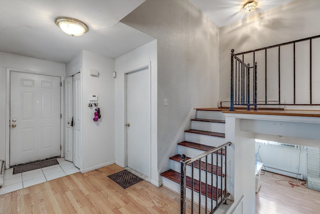 29190 Heritage, Southfield, MI 48076 - entryway featuring a baseboard radiator, wood finished floors, baseboards, and stairway