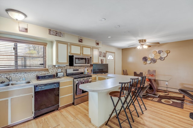 29190 Heritage, Southfield, MI 48076 - kitchen with stainless steel appliances, light countertops, a sink, light wood-style floors, and decorative backsplash