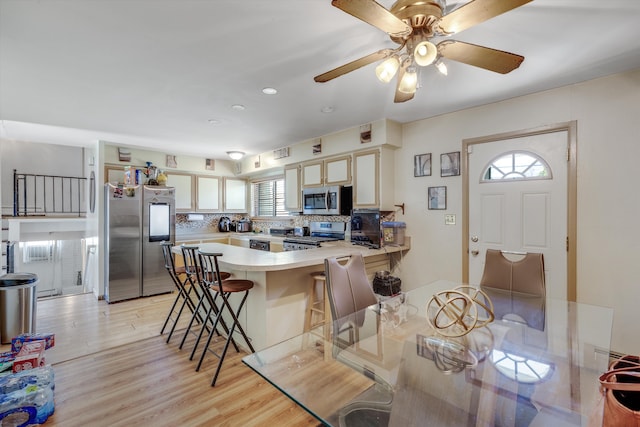 29190 Heritage, Southfield, MI 48076 - kitchen with light wood finished floors, a peninsula, tasteful backsplash, light countertops, and appliances with stainless steel finishes