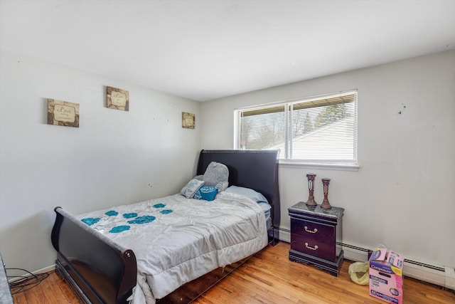 29190 Heritage, Southfield, MI 48076 - bedroom featuring a baseboard heating unit and wood finished floors