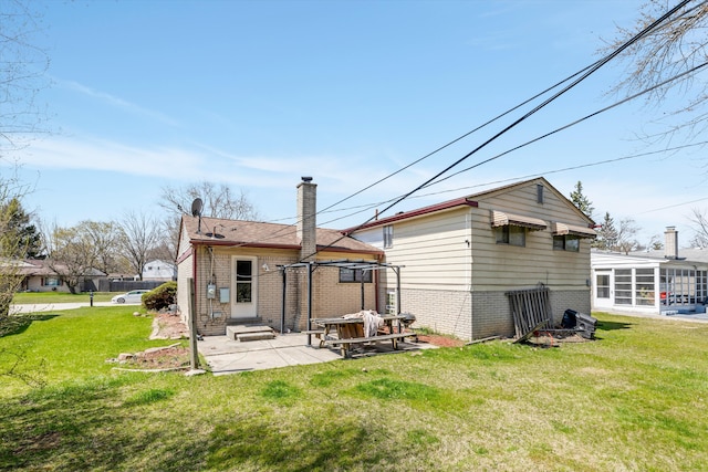 29190 Heritage, Southfield, MI 48076 - rear view of property with a lawn, a chimney, brick siding, and a patio area