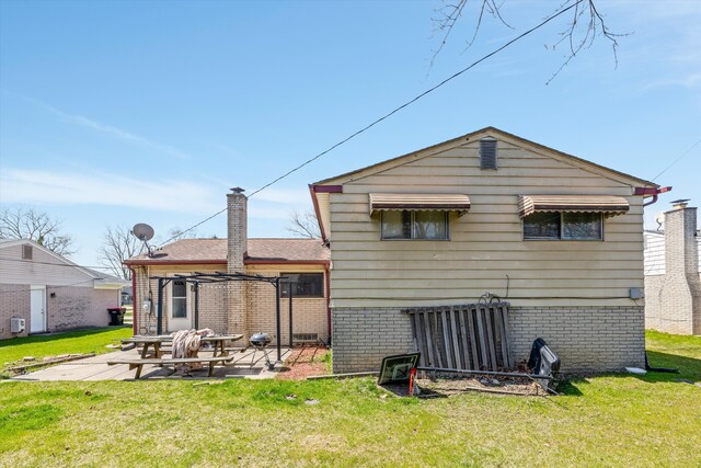 29190 Heritage, Southfield, MI 48076 - back of house featuring a patio area, a lawn, a chimney, and brick siding