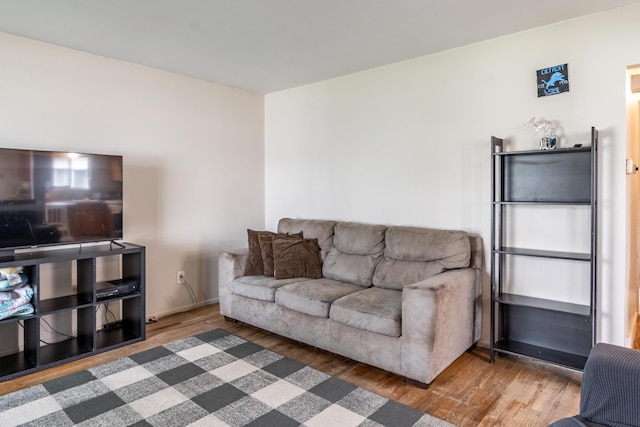 living room featuring wood finished floors and baseboards