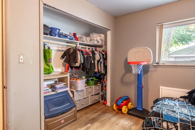 bedroom featuring wood finished floors and a closet