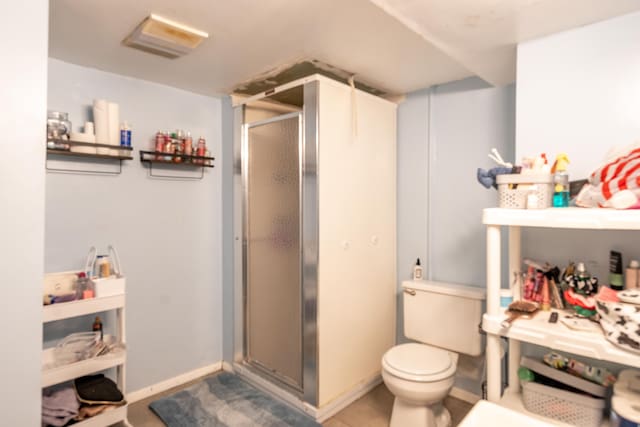 full bath with a stall shower and toilet