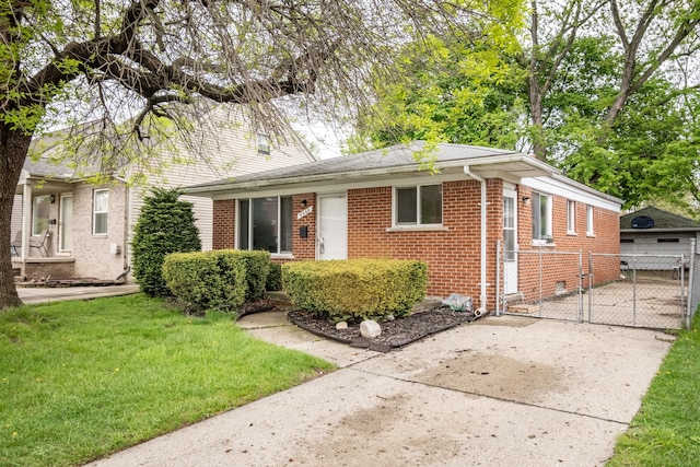 ranch-style house with brick siding, a gate, and concrete driveway