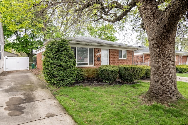view of front of house with a gate and brick siding