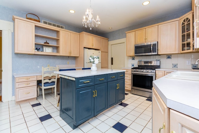 kitchen with appliances with stainless steel finishes, light brown cabinets, light countertops, blue cabinets, and recessed lighting