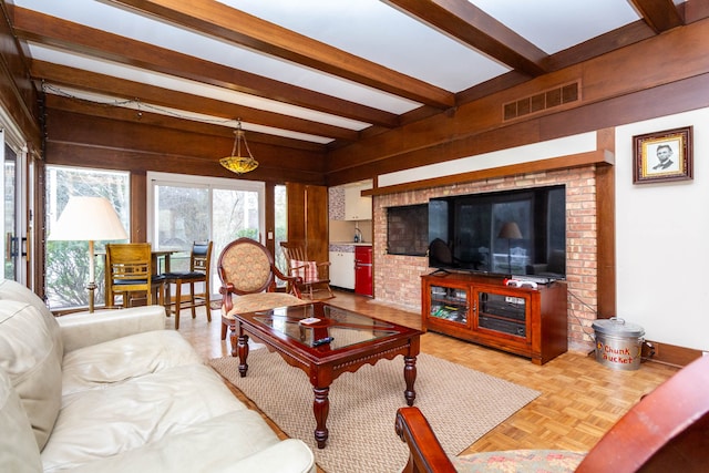 living area featuring beamed ceiling