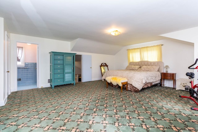 bedroom featuring carpet flooring, vaulted ceiling, ensuite bathroom, and baseboards