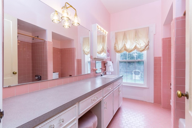 bathroom featuring vanity, a chandelier, a shower, and tile patterned floors