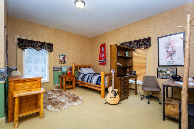 carpeted bedroom featuring a desk and wallpapered walls