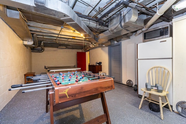 rec room featuring concrete block wall