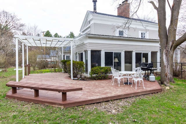 back of house featuring a pergola, a wooden deck, a chimney, and outdoor dining space
