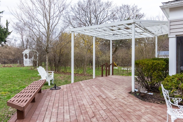 wooden deck featuring a lawn and an outdoor fire pit