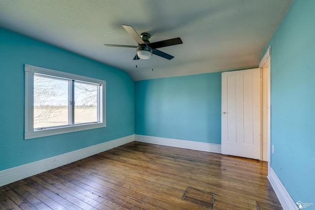 empty room featuring baseboards, a ceiling fan, and hardwood / wood-style flooring