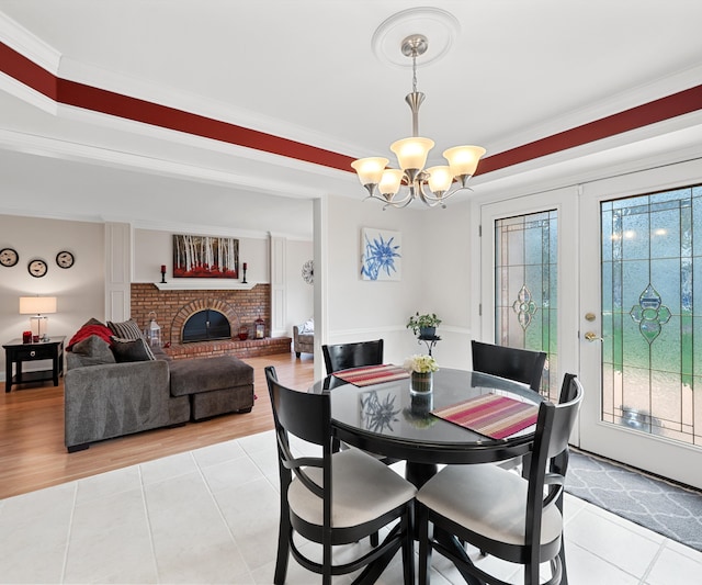 dining space featuring a notable chandelier, light tile patterned flooring, and a wealth of natural light