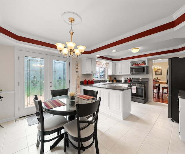 dining area with an inviting chandelier, a raised ceiling, ornamental molding, and light tile patterned floors