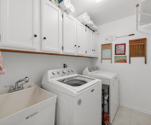 laundry room featuring cabinet space, washing machine and clothes dryer, a sink, baseboards, and light tile patterned floors
