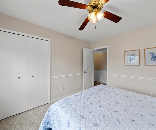 carpeted bedroom featuring ceiling fan and a closet