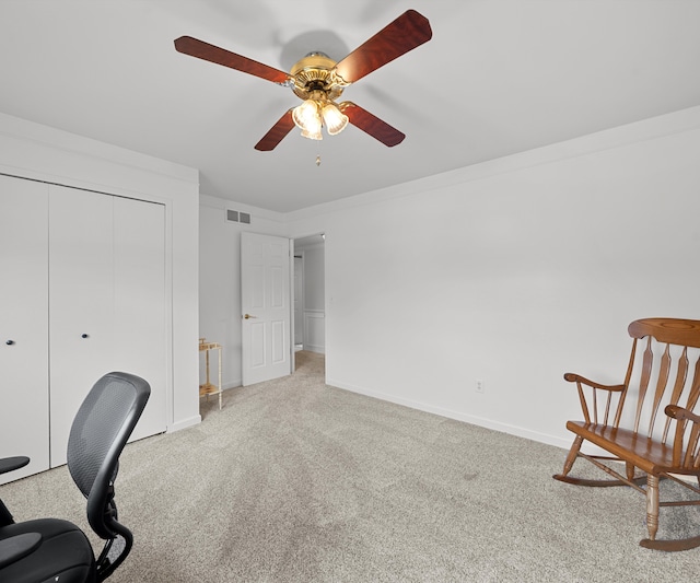 carpeted home office with ceiling fan and baseboards