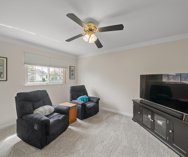 sitting room featuring baseboards, ceiling fan, and carpet