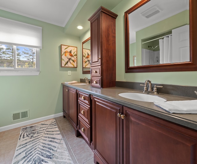 bathroom featuring a sink, baseboards, and visible vents