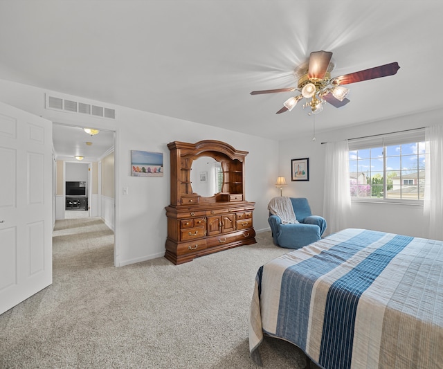 bedroom featuring visible vents, a ceiling fan, and carpet floors