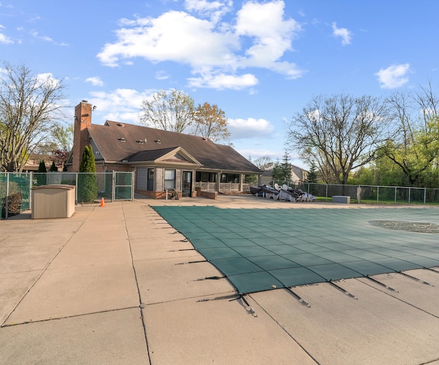 pool with fence and a patio area