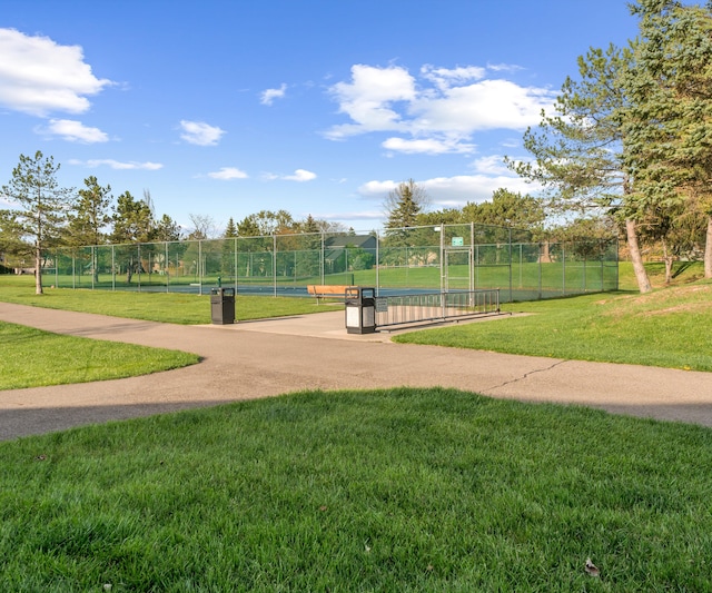 view of community with a yard and fence