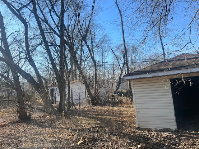 19763 Gilchrist St, Detroit, MI 48235 - view of yard featuring an outdoor structure, fence, and a storage unit