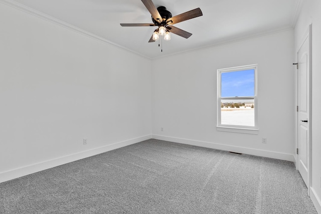 carpeted empty room with visible vents, baseboards, crown molding, and a ceiling fan