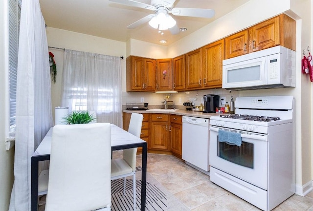 kitchen with tasteful backsplash, light countertops, ceiling fan, white appliances, and brown cabinets