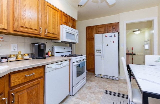 kitchen featuring light countertops, ceiling fan, white appliances, brown cabinetry, and backsplash