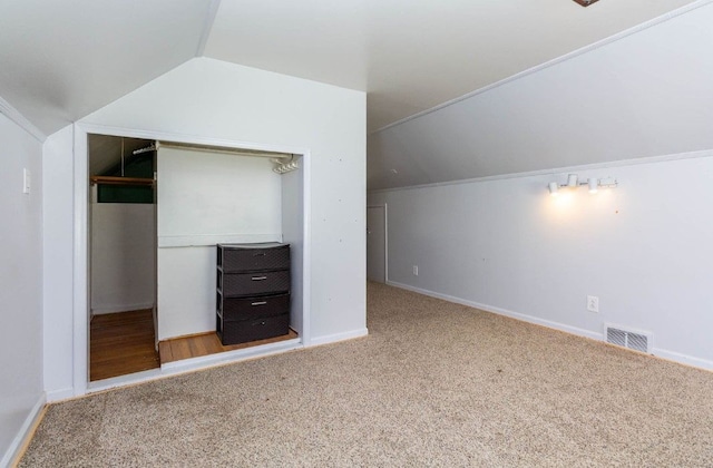 bonus room with visible vents, baseboards, carpet floors, and lofted ceiling