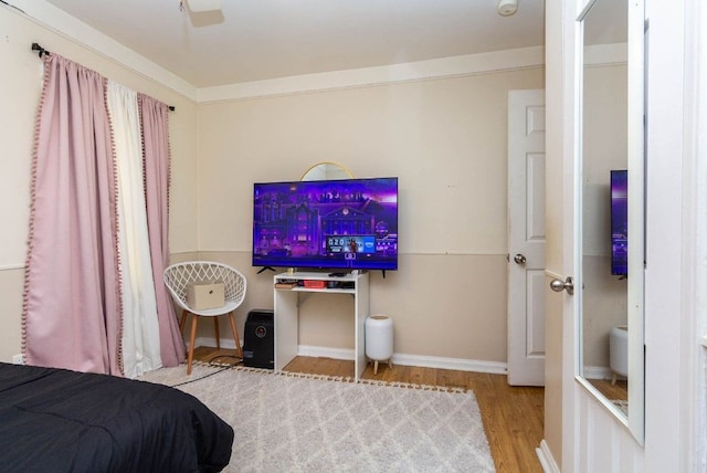 bedroom with baseboards and wood finished floors