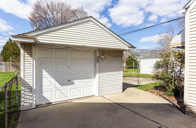 detached garage with driveway and fence