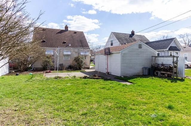 rear view of property with a yard and a chimney