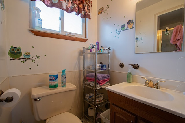 bathroom featuring toilet and vanity