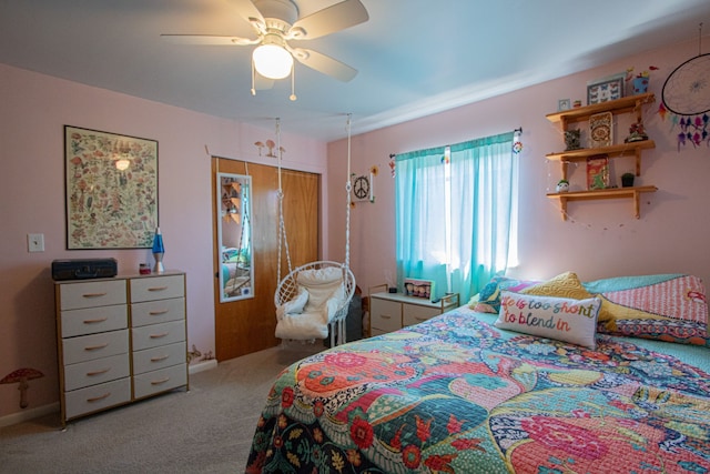 carpeted bedroom with a ceiling fan and a closet