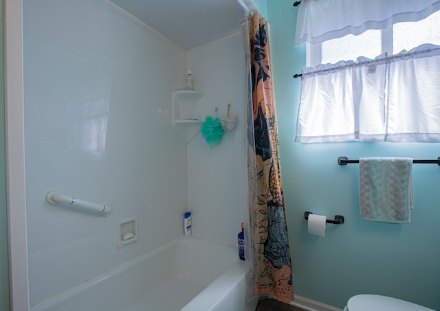 full bath with toilet and shower / bath combination with curtain